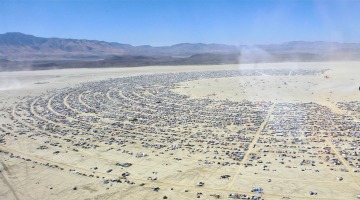 aerial view of large festival campsite in desert